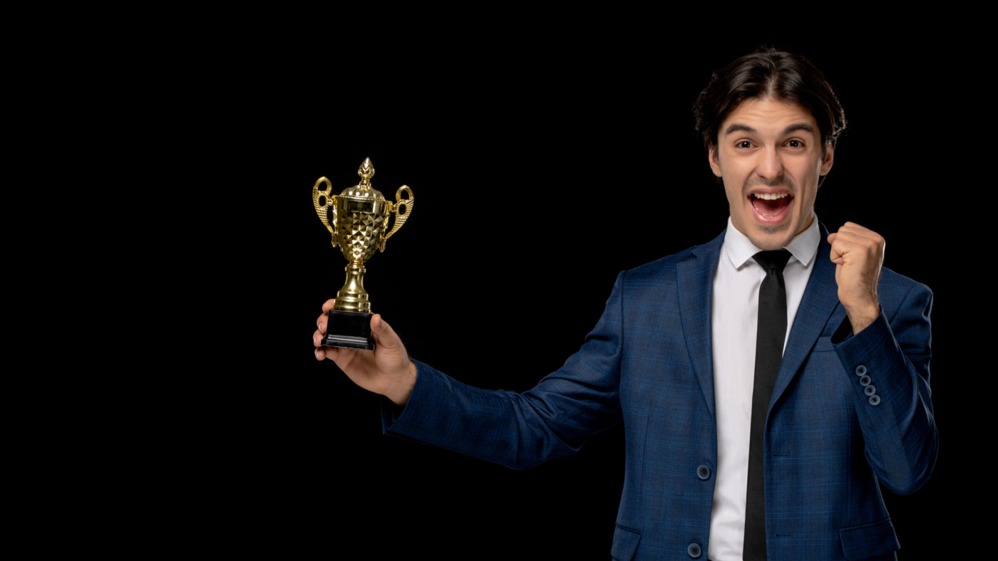 business-man-cute-excited-man-dark-blue-suit-with-tie-holding-trophy